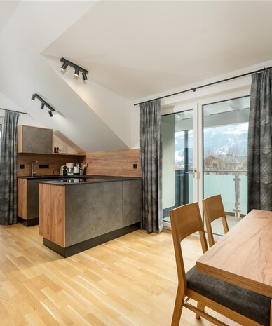 Modern kitchen and dining area with wooden surfaces