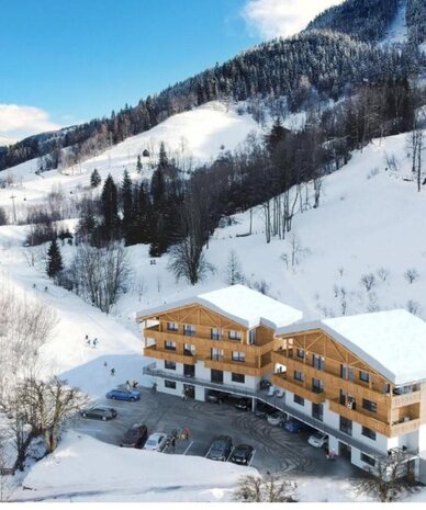 Snowy mountain lodge with wooden chalet buildings