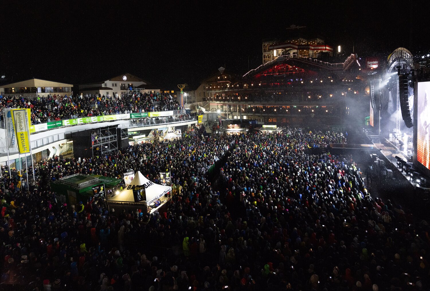 Large nighttime outdoor concert crowd gathered before illuminated stage | © Harald Steiner