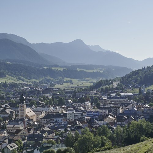 Small town nestled in a valley with distant mountains