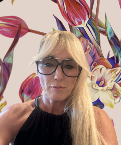 Blonde woman with glasses in front of vibrant mural