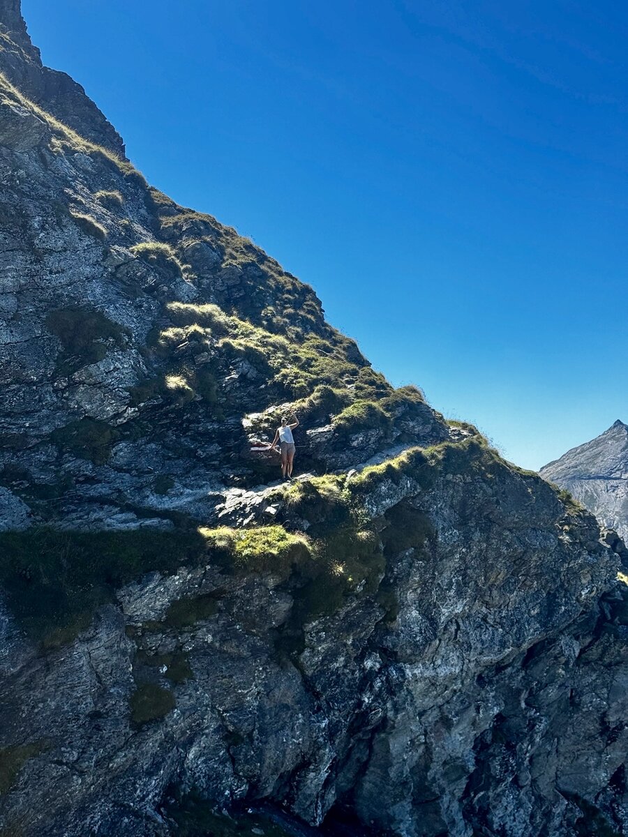 Rugged rocky hillside with a hiker near center