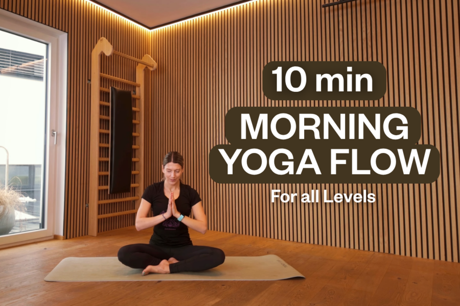 Person sits cross-legged on yoga mat; overlay shows 10-minute Morning Yoga Flow | © Maria Gruber
