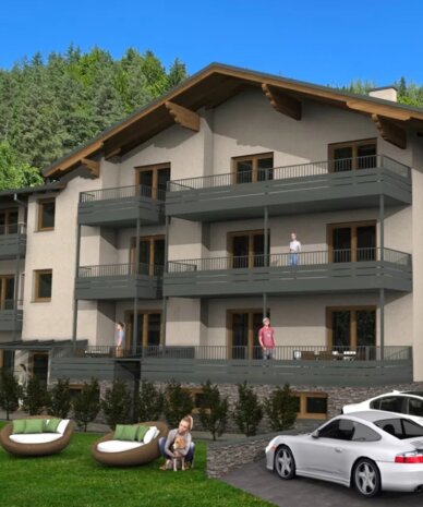 Dreigeschossiges Wohngebäude mit Balkonen, parkenden Autos und Bäumen.