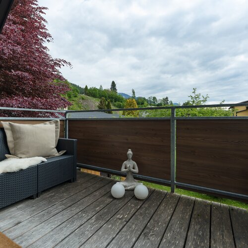 Outdoor balcony with wicker seats and cushions