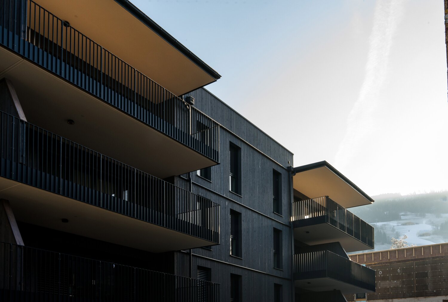 Modernes dunkles Wohngebäude mit mehreren Balkonen