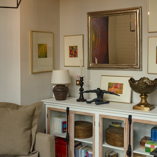 Living room corner with multiple framed artworks