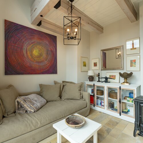 Cozy living room with beige sofa and wall art