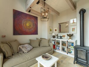 Cozy living room with beige sectional and abstract circular painting