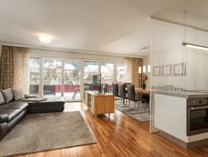 Bright open-plan living area with sofa and balcony