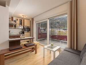 Bright open-plan kitchen and living room with balcony view