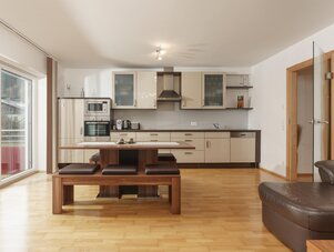 Open-plan kitchen with island and dining bench
