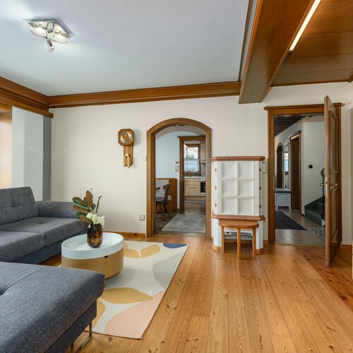 Living room with gray L-shaped sofa and wooden floors