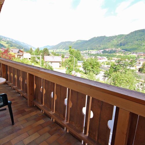 Balcony with wooden railing and scenic valley view