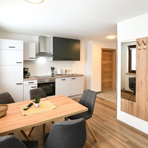 Open-plan kitchen and dining area with wooden flooring