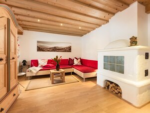 Cozy living room with red sectional sofa and white wood-burning stove
