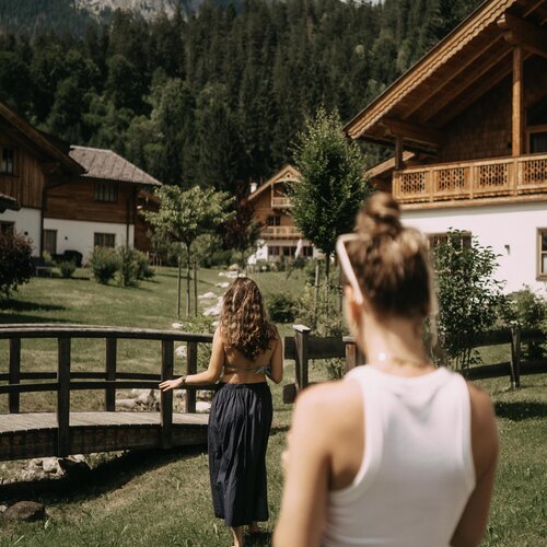 Two women in a mountain village near wooden chalets