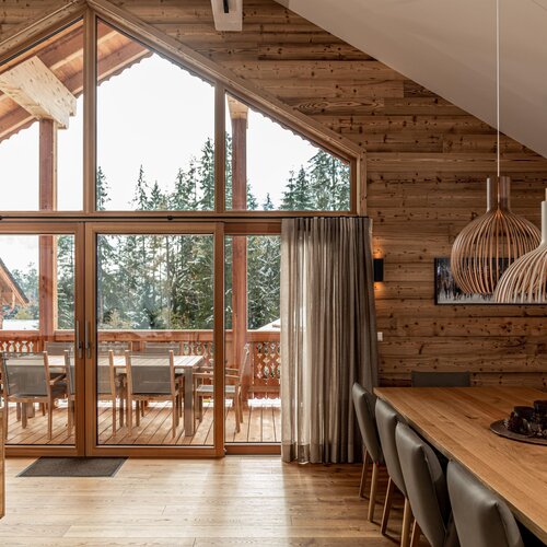 Wooden cabin dining area with large glass doors