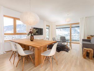 Living room with wooden dining table and mountain view