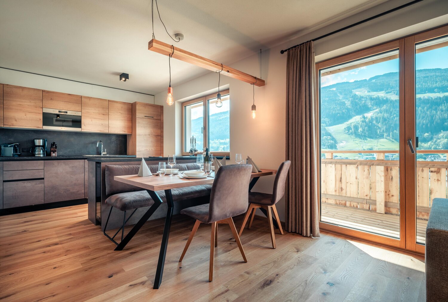 Open-plan kitchen and dining area with wooden furniture and mountain view