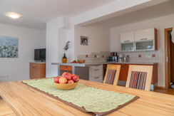 Dining table and kitchen view Dining table and kitchen view