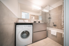 Bathroom with bathtub and integrated shower Bathroom with bathtub and integrated shower